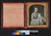 [Woman holding deceased girl in striped dress]