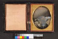 [Deceased boy holding book and basket]