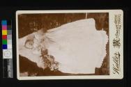 [Deceased infant in christening gown]