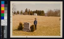 [Boy posing by the gravestone of Connie Ray Love, 1960-1965.]