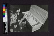 [Baby laid out in white coffin]