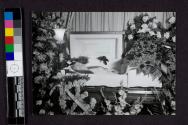 [Elderly woman laid out in coffin with long hair loose]