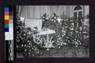 [Elderly woman laid out in coffin with long hair loose]