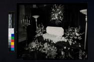 [Deceased baby laid out with "Butchie" banner]