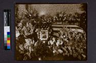 [Portrait of officer by flag-drapped coffin]