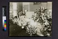 [Woman laid out with "Mother" funeral arrangement]