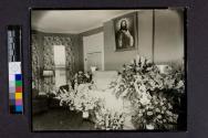 [Woman laid out with "Mother" funeral arrangement]