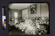 [Woman laid out with "Mother" funeral arrangement]