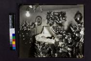 [Man laid out in coffin with photograph of man in uniform]