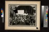 [Elderly man laid out with "Dad" floral arrangement]