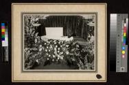 [Elderly man laid out with "Dad" floral arrangement]