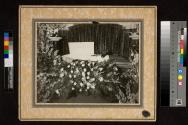 [Elderly man laid out with "Dad" floral arrangement]