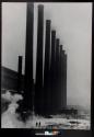 [Smokestacks and train]