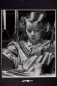 [Handicapped child painting with watercolors]