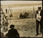 Beachgoers on the Riviera, newspaper vendor carrying "Le Journal"