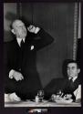 [Man speaking at dinner]
