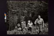 [Father Daniel Linehan leading a field crew through the Maine woods, to the Kennebeck River to investigate by seismic methods the choice of a new dam site.]