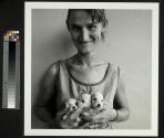 Wife of Abattoir Worker Holding 3 Puppies…