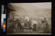 [Man with camera taking group picture]