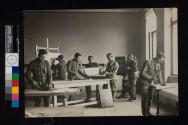 [Soldiers inside photo studio]
