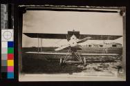 [Biplane near hangers]
