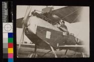 [Man in cockpit of plane]
