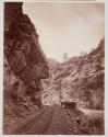 [Working the road under Hanging Rock, near Clear Creek Canyon]