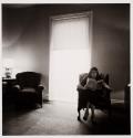 Lady in a rooming house parlor, Albion, NY