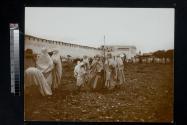 [Group of women standing outside town wall]