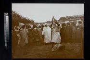 [People gathered around snake charmer]