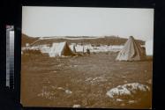 [Tents set-up outside town wall]
