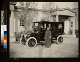 George Eastman's Chauffeur and automobile in front of Carriage House
