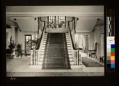 Front view of grand staircase showing french doors & windows opening into the conservatory
