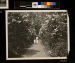 Woman & Child walking through George Eastman's garden 