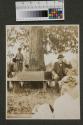 Walter Hubbell beside children under tree, Oak Lodge trip