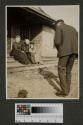 Guests being photographed on porch, Oak Lodge trip