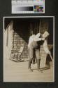 Walter Hubbell sweeping porch, Oak Lodge trip