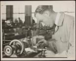 Fine adjustment on cutting tool. A high-school lad learning...