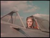 [Woman pilot in open cockpit]