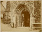 [Man standing in church doorway]