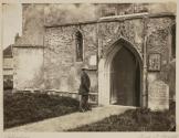 [Man standing next to church door]