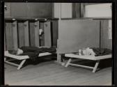 [Children sleeping on cots]