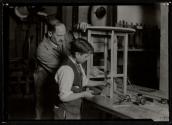 [Student & teacher in wood shop, working on table]