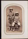 [Two men wearing ponchos and hats]