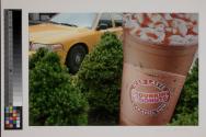 [Cab and oversized sign for "Dunkin' Donuts" iced latte]