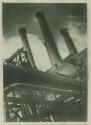 [Four smokestacks and pipes]