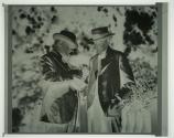 George Eastman shows Thomas Edison a Cine-Kodak Model B camera at the Kodacolor Party