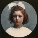 [Young girl with red hair and a blue hair bow]