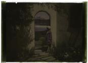 [Woman in garden doorway]