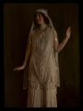 [Woman in gold costume]